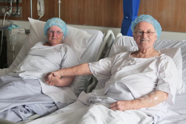Husband and wife, Margaret and Gary, in a hospital bed at Austin Hospital before living donor kidney transplant surgery